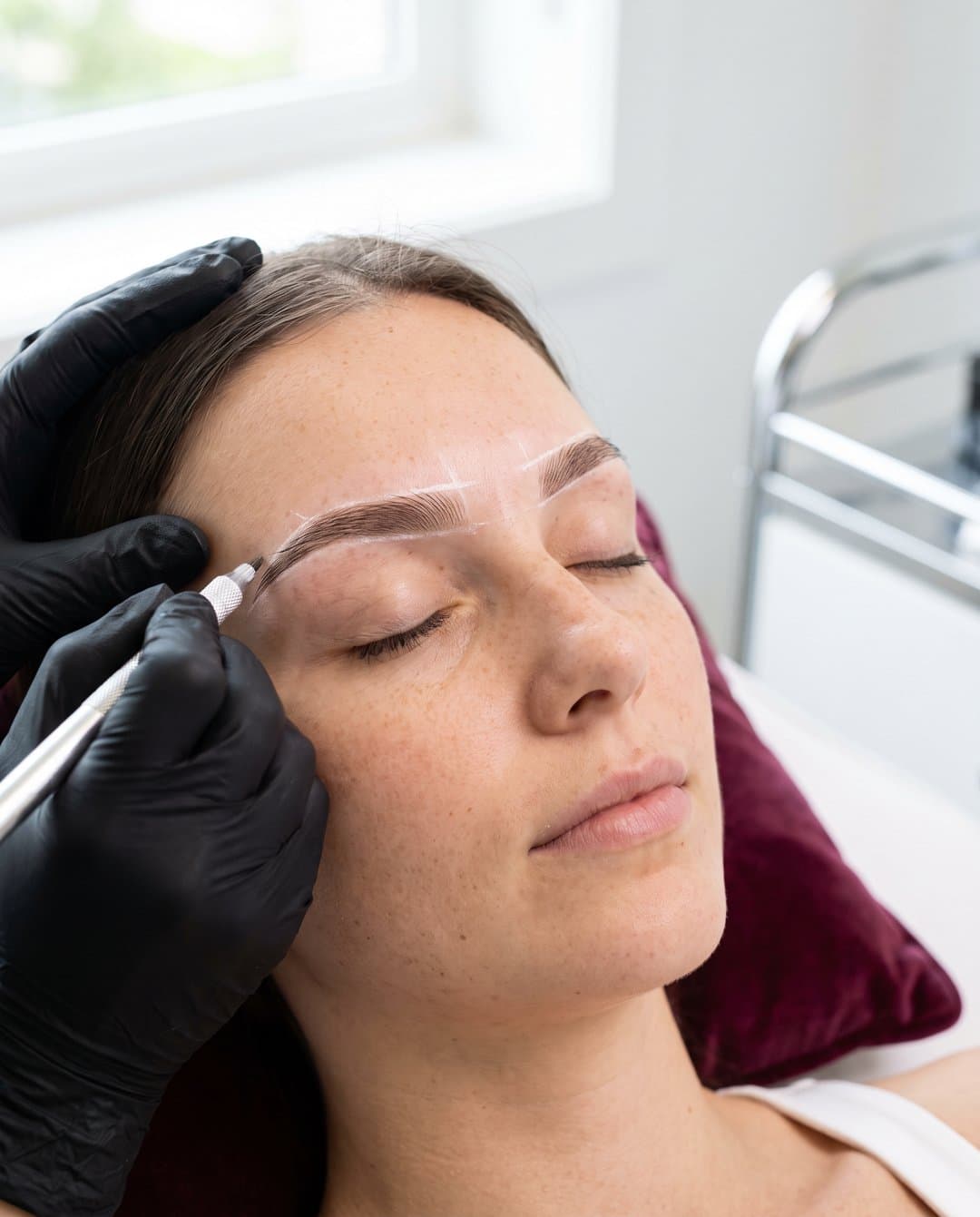 Illustrative image of a cosmetic eyebrow tattoo being drawn hair by hair