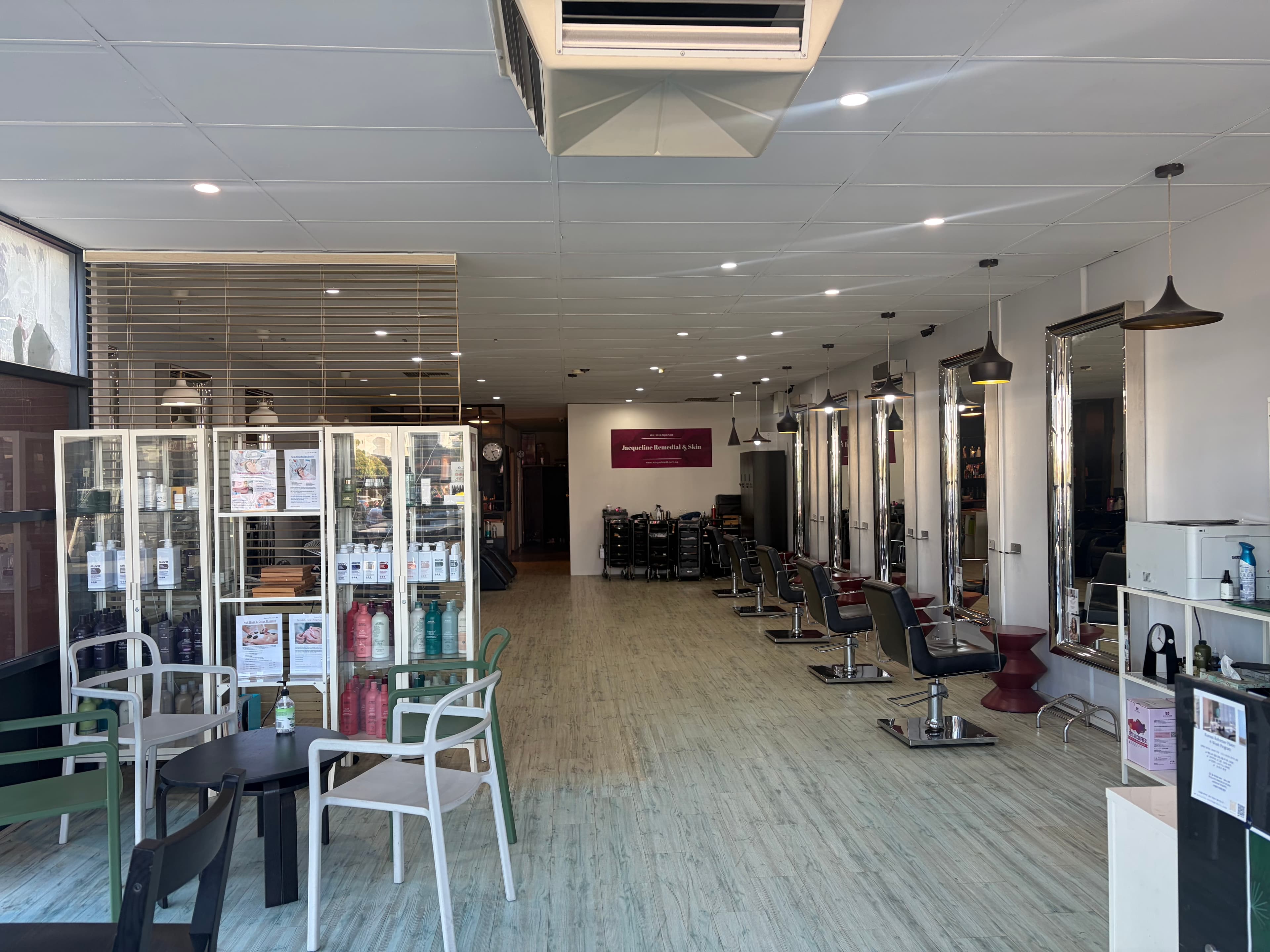 The Jacqueline Hair & Beauty salon floor in Myaree — chrome mirrors, styling chairs and the Aveda product wall